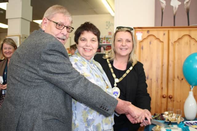 Long-standing volunteers Barbara and Roy Greaves cut the cake with Littlehampton mayor Tracey Baker
