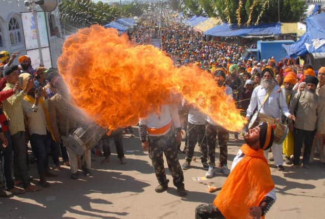 One bag of chilli-flavoured crisps too many?  An Indian Sikh performs fire-breathing during a religious procession to mark Hola Mohalla.  Photo by Shammi Mehra/AFP/Getty Images)