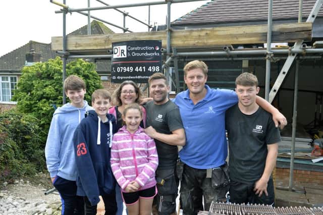 The Williams family, Oliver, Jacob, Lilly and mum Victoria with builders Derek Roy, Lewis Pendry and Kieron Davies (Photo by Jon Rigby) SUS-191021-140252008