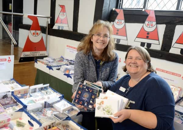 ks190597-1 Midhurst Christmas Cards  phot kate Jane Tingley,area manager or Cards for Good Causes and Kirstin Bosley co-manager in the Old Library in Midhurst launching this years event.ks190597-1 SUS-191029-234810008