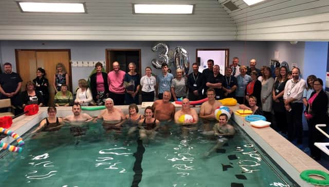 Staff and patients celebrate 30 years of Aquatic Physiotherapy at Eastbourne DGH (Anna Carter Lead Aquatic Physiotherapist centre in pool)