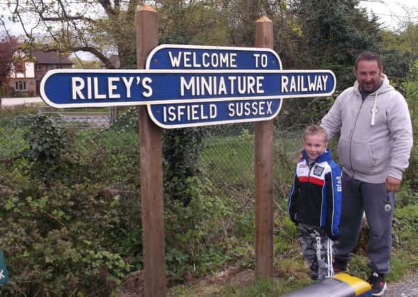 Riley with his dad, Darryl, in front of Riley's Miniature Railway based at the Lavender Line, Isfield Station