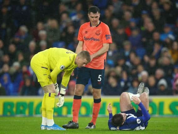 Brighton striker Aaron Connolly is on the floor after contact from Everton defender Michael Keane