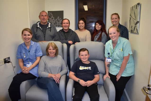 Berwick ward staff with Michelle Lewis with her family on the two new reclining chairs they donated