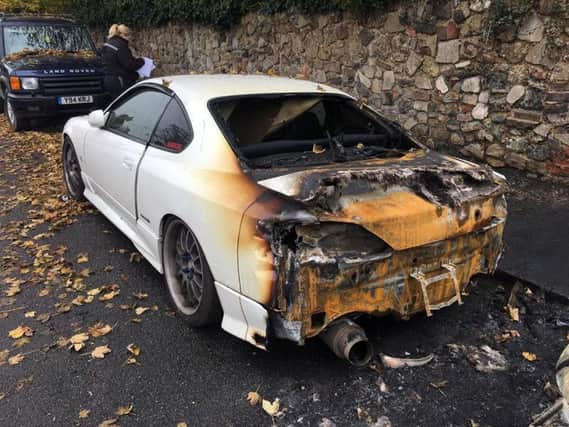 The damage done to the back of Harry's car
