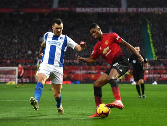 Brighton and Hove Albion's Pascal Gross closes in on Manchester United's Marcus Rashford