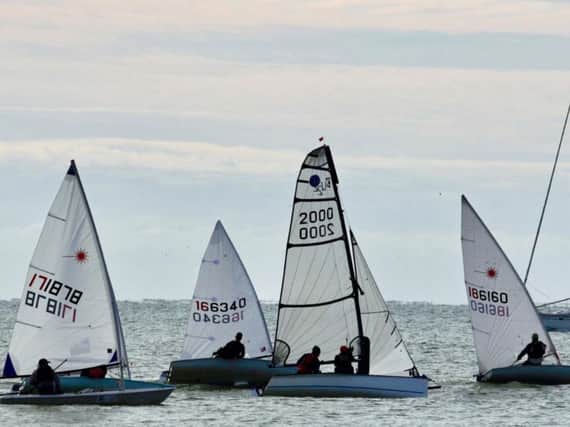 Boats racing in the Winter Series with a yacht passing close by. Picture by Rick Pryce