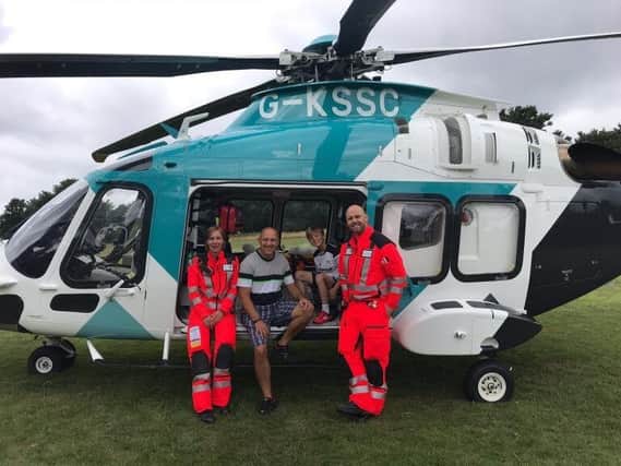 Darren, his son Tyler and the Kent, Surrey and Sussex Air Ambulance team