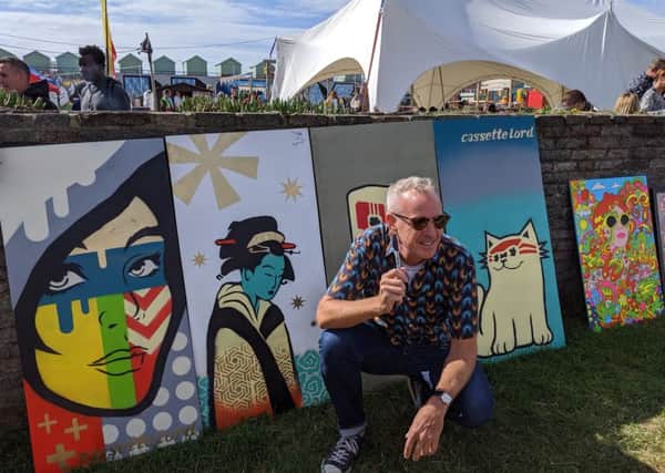 DJ Fatboy Slim with the four Cassette Lord Murals at this year's LagoonFest. Photograph: Maxine Saca McMinn