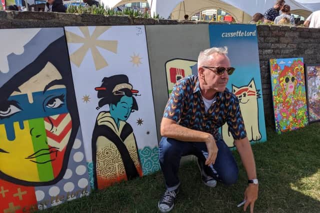 DJ Fatboy Slim with the Cassette Lord murals at this year's LagoonFest. Photograph: Maxine Saca McMinn