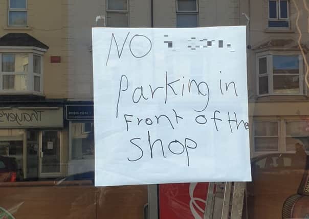 The 'offensive' sign in the window of an Eastbourne shop - with swear word blurred out