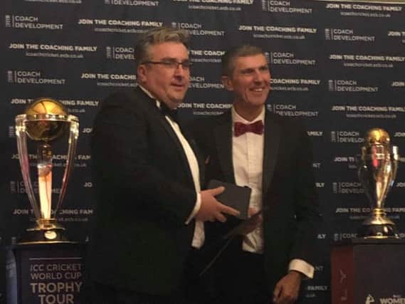 Paul Hacker (left) being presented the award by former England Women's coach Mark Robinson. Photo courtesy of Eastbourne CC
