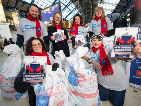 American Express colleagues collecting coats at Brighton Station