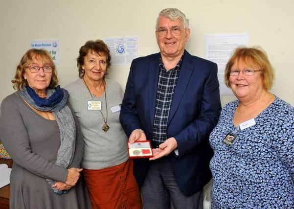 Mike Nicholls has been awarded a BEM for services to the community, pictured here with colleagues