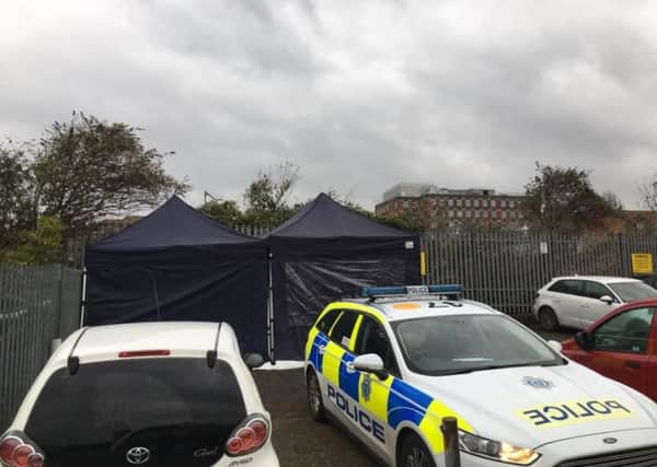 Scene of crime officers set up tents in Ashford Square, Eastbourne