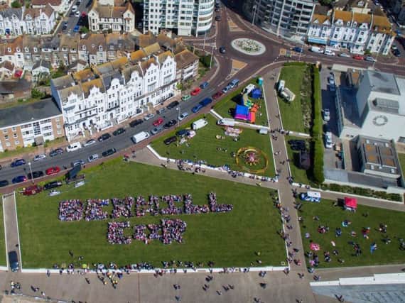 An aerial image of people forming the words Bexhill ER to celebrate Prince Harry and Meghan Markle's wedding in May 2018. Photo by Sussex Air Imaging