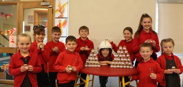 Pupils from St Thomas C of E Primary School in Winchelsea raising funds for the RNLI with Betty's 5p pots SUS-200213-132354001
