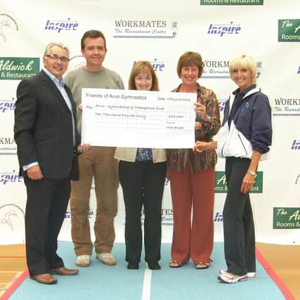 The friends group hand over the cheque for the tumble track