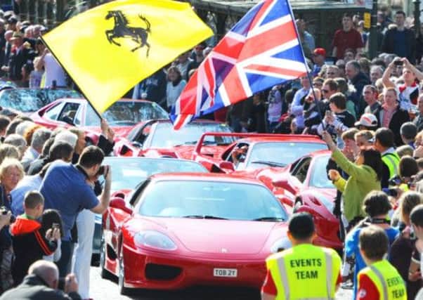 JPCT 06-04-12 Piazza Italia, Horsham. HDC Chmn Claire Vickers raises flag to start the Ferrari procession S12150189a -photo by Steve Cobb
