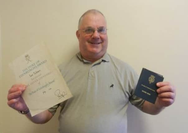 Ian Tickner with the DofE Silver Award certificate and record book from 1962
