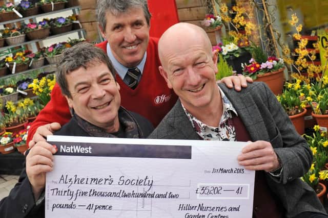 JPCT 010313 £35,175 Presented to Charity as Hillier Garden Centre starts celebration weekend. L to R TV actor Richard Hawley, star of the BBC series The Vet, Terry Clarke, garden centre manager at Hillier Horsham and Andy McIndoe managing director of Hillier. Photo by Derek Martin