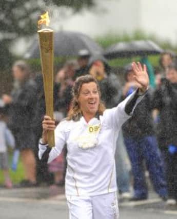 Sally Gunnell carries the Olympic flame through Bognor Regis.

C120939-26 Bog july19 Torch  Photo Louise Adams