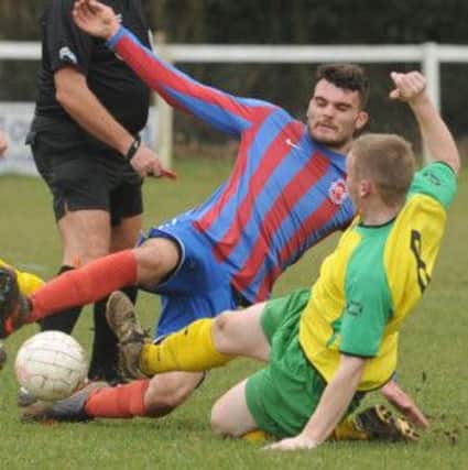 Andy Hounsome (in yellow) in action for Sidlesham at Barnham  Picture by Louise Adams C130340