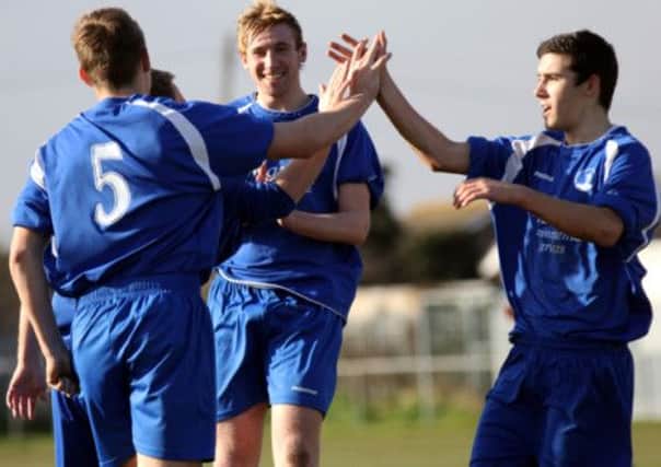 Conor Cody celebrates with his Selsey team-mates after scoring versus Horsham YMCA  Picture by Chris Hatton