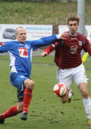Hastings United striker Zac Attwood tries to take on a Leiston defender. Picture by Terry S. Blackman