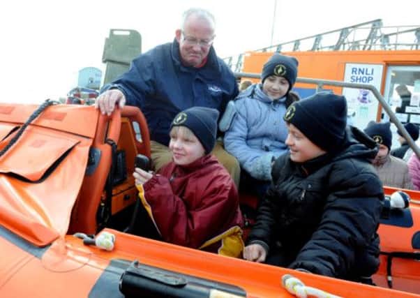 C130362-1 Chi Chernobyl  phot kate  Chairman of the RNLI Selsey Lifeboat station with children visilting from Chenobyl, inclluding Dasha Makhirko, ten,, Ksenia Kharlanchuk, ten and Igor Khahovich, 11.Picture by Kate Shemilt.C130362-1
