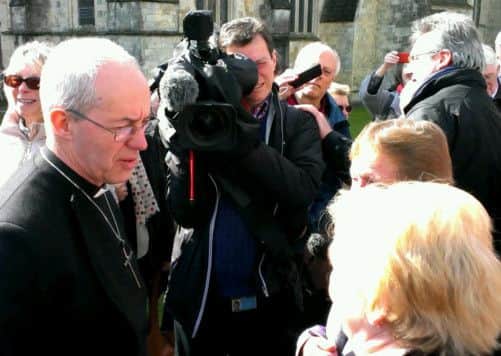 Archbishop Justin Welby speaks to the public outside Chichester Cathedral on March 19.