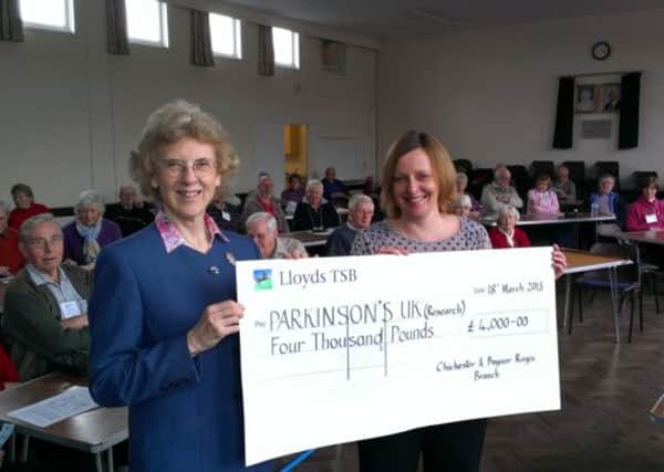 Branch treasurer Margaret Huntingdon presents the cheque to Alyson Smith for Parkinson's research