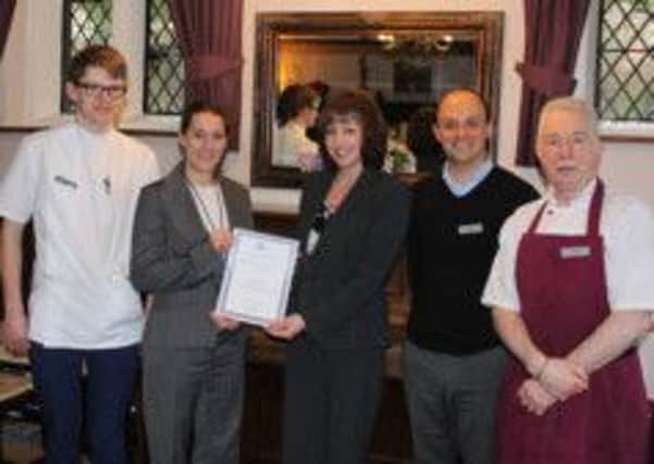 Zoë Bates, owner of Valerie Manor, receives her Horsham Healthy Workplace Award from Sue Rogers