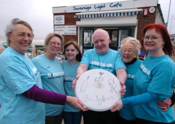 Diabetes UK, Hastings and Rother Voluntary Group promote their fund raising seafront walk and a raffle which will include the signed drumskin from internationally famous local band Keane who wrote a song about the Sovereign Light Cafe. March 25th 2013 E13097P