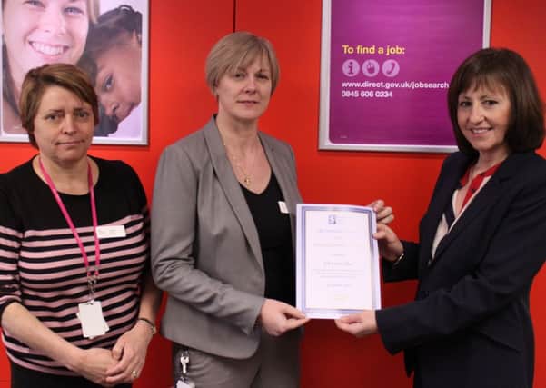 Horsham job centre plus wins Gold Workplace Award. Cllr Sue Rogers, right, presenting the Gold Workplace Health Award to Kathie Gallie, centre, and Alison Finn, left, from Job Centre Plus in Horsham.