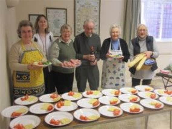 Fernhurst Good Companions prepare for their biannual  Ploughman's lunch in the village hall.