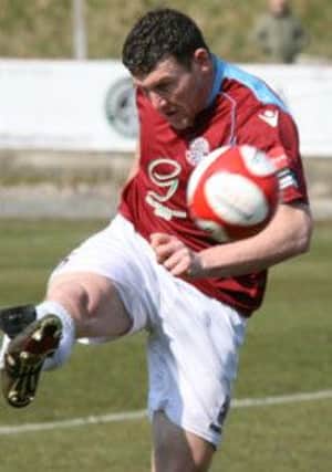 Hastings United player-manager Sean Ray hooks the ball forward against Whitehawk yesterday. Picture by Terry S. Blackman