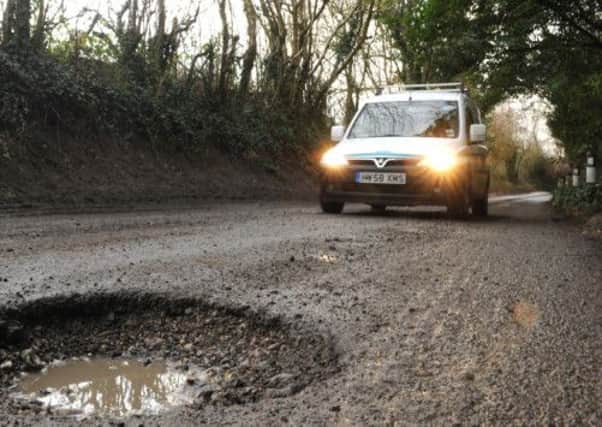 Watch out for deep potholes in the Midhurst area.

Photo by Louise Adams C130023-2 Mid Potholes