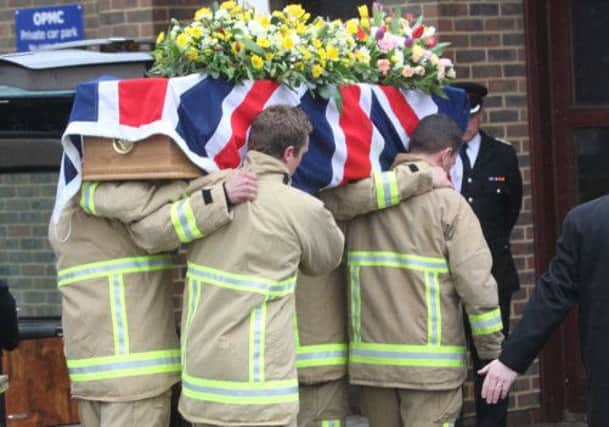 Firefighters carrying Arthur's coffin