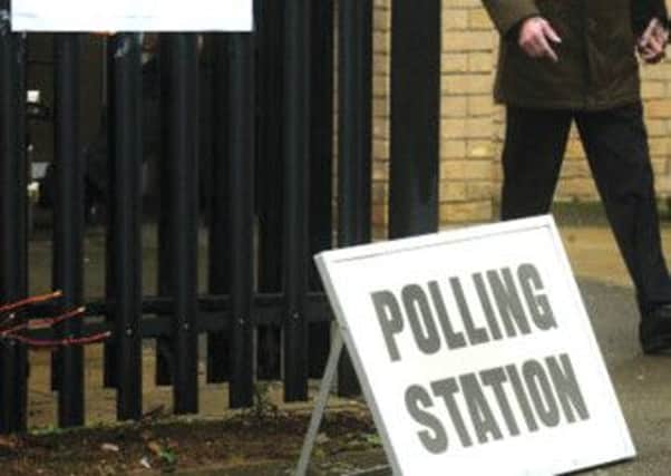 Voters arrive to vote in the by-election at a polling station at Corby Community Centre, Corby, Northamptonshire.