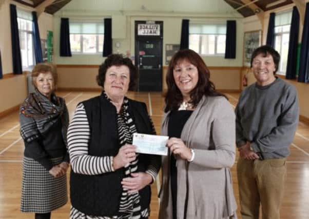 Barratt donates a cheque for Southwater Village Hall. Picture submitted