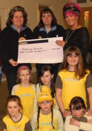 Lesley Edwards (right) presents Harvest Fair cheque to Pulborough Brownies