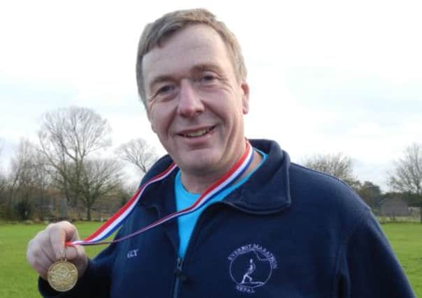 Nick Bailey with his Everest Marathon medal

Picture by Clare Hawkin
