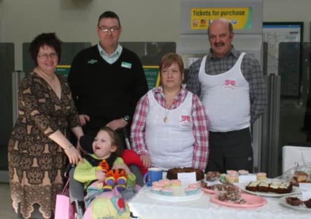 Iona-May Thorne with railway staff from Littlehampton and family during a fund-raising cake sale at the Worthing railway station.