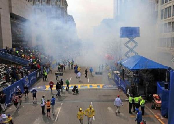 Medical workers aid injured people at the 2013 Boston Marathon. (AP Photo)