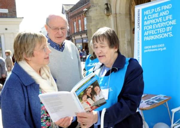 Volunteer Myrtle Gray talking to June and Eddie Saunders about Parkinsons. Picture by Kate Shemilt. C130551-1