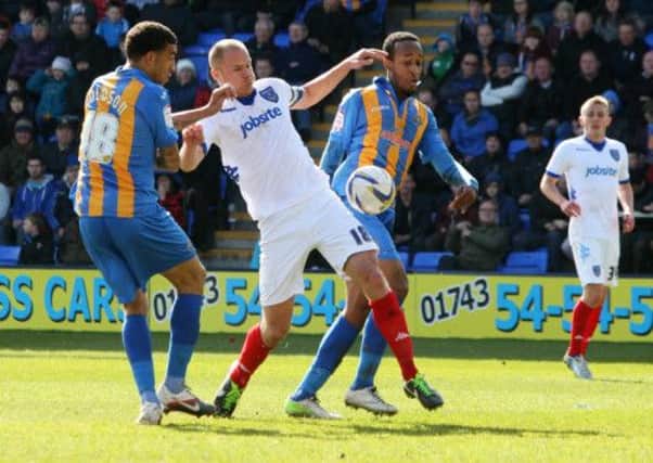 Pompey skipper Johnny Ertl battles for the ball at Shrewsbury   Picture: Joe Pepler