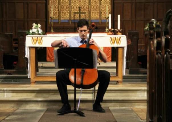 Cellist Tim Moses performs at the recital