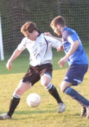 Sidley forward Matt Darby tussles for possession with Bexhill defender Josh Elliott-Noye. Picture by Simon Newstead.