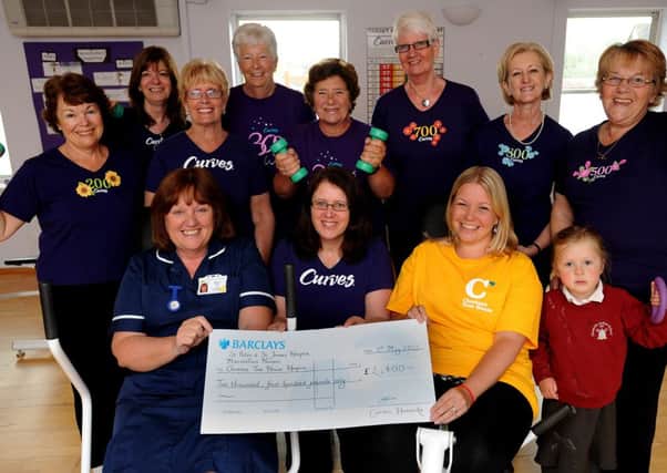 Curves Hassocks raise £ 2,400 for local charities. Pictured with Margaret Scully from St Peters and St James's Hospice and Jayne Todd from Chestnut Tree House are Curves members. MacMillan also received a share of the proceeds.